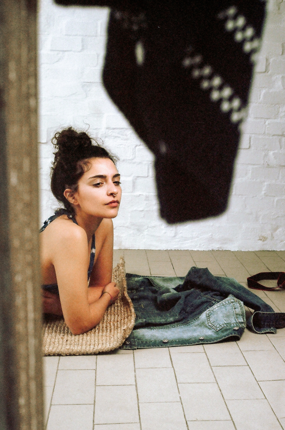 Ritratto di ragazza allo specchio con muro di mattoni sullo sfondo, fotografia analogica